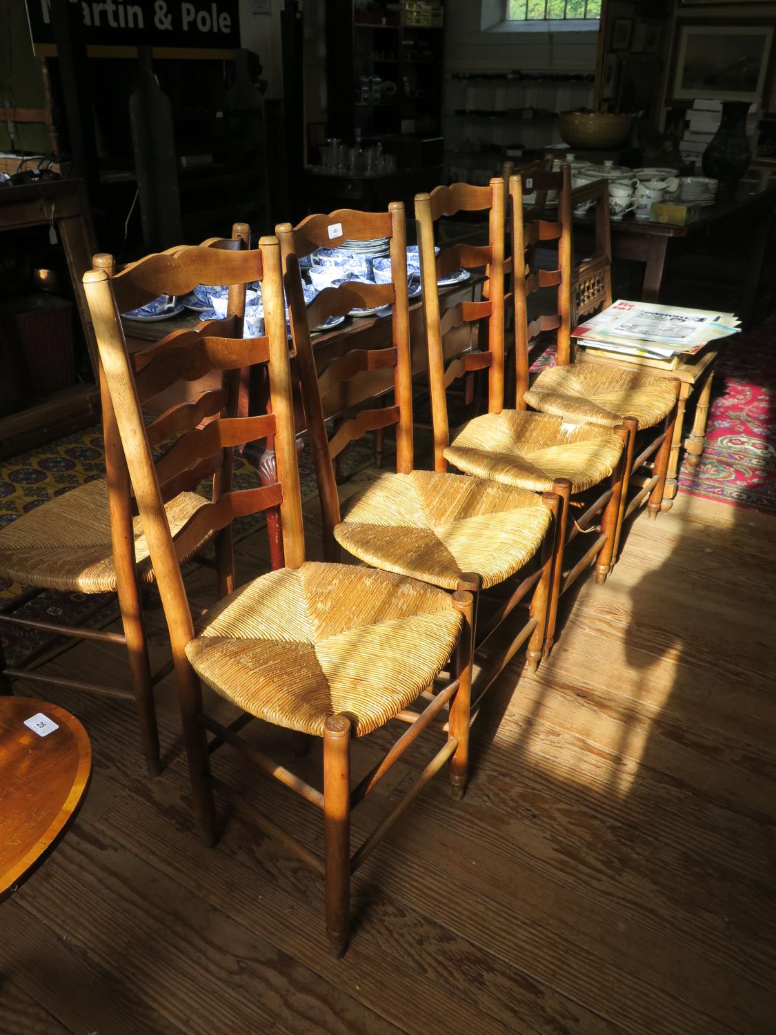 A set of six 19th century French ash ladderback dining chairs with rush seats, on turned legs and