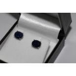 Pair treated oval sapphire studs, in silver