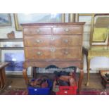 A George II crossbanded walnut chest on later stand, with two short and two long drawers on a