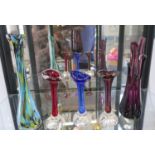 Coloured glass including one amethyst, one red and one blue flared-rim vases, 17cm, a pale blue,
