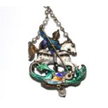 An enamelled pendant depicting St George slaying the dragon, 6 cm long, and a pair of costume