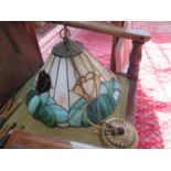 A stained glass ceiling light shade, with floral motif on a beige and green ground, 41 cm diameter