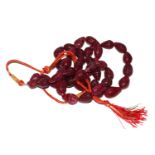 Earth mined 2 strand red carved pear shaped bead necklace with an adjustable cord and with tassle.