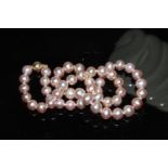 A Freshwater cultured pink pearl necklace with a 9ct yellow gold ball clasp