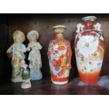 A pair of 19th century continental figures, a small bisque figure and two Japanese vases