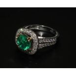 A 14ct white gold emerald and diamond ring with split diamond-set shoulders. Emerald 1.88ct, approx.
