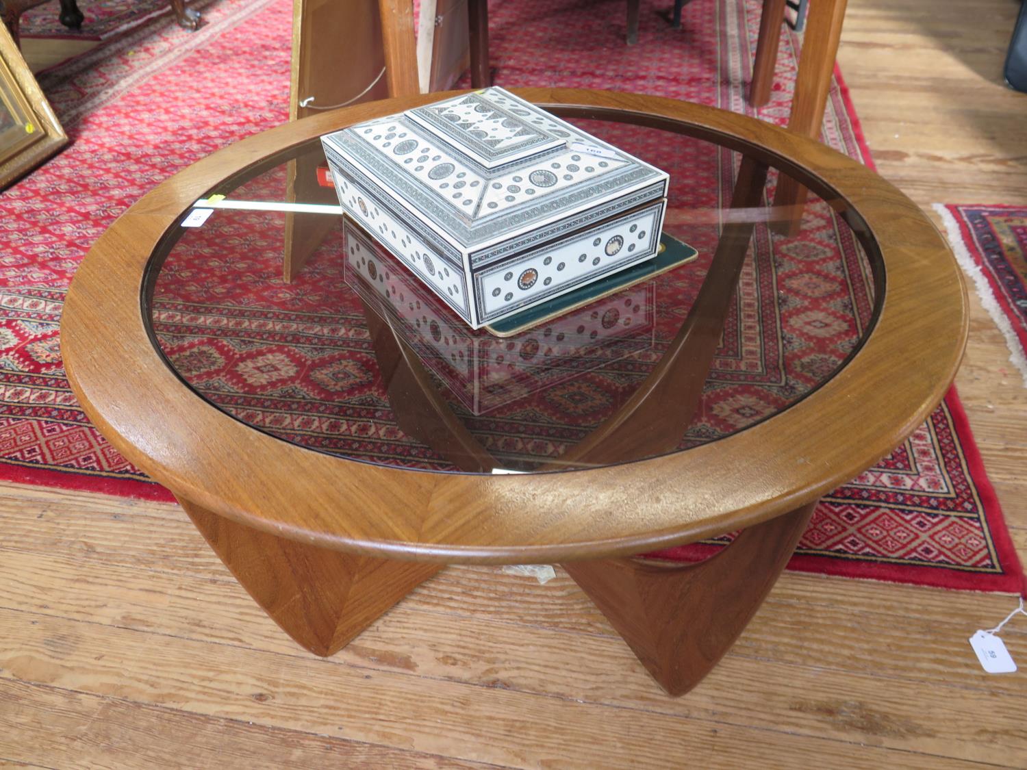 A G-Plan teak circular coffee table, with smoked glass top, 83.5 cm diameter