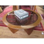 A G-Plan teak circular coffee table, with smoked glass top, 83.5 cm diameter