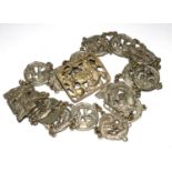 A white metal belt comprised of roundels decorated with oriental designs, as found
