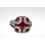 A platinum art deco style ring set with rubies and diamonds. Size M and a half