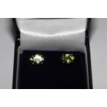 Pair oval peridot studs, in silver