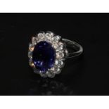 An 18ct white gold good quality oval tanzanite and diamond cluster ring. Tanzanite 4.55ct.