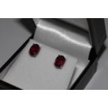Pair treated oval ruby studs, in silver
