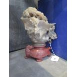 A large soapstone cup, carved with dragons, on a red stone tortoise form base, 25 cm high, with box