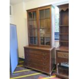 A George III oak chest of drawers, with associated bookcase, the bookcase with glazed doors and