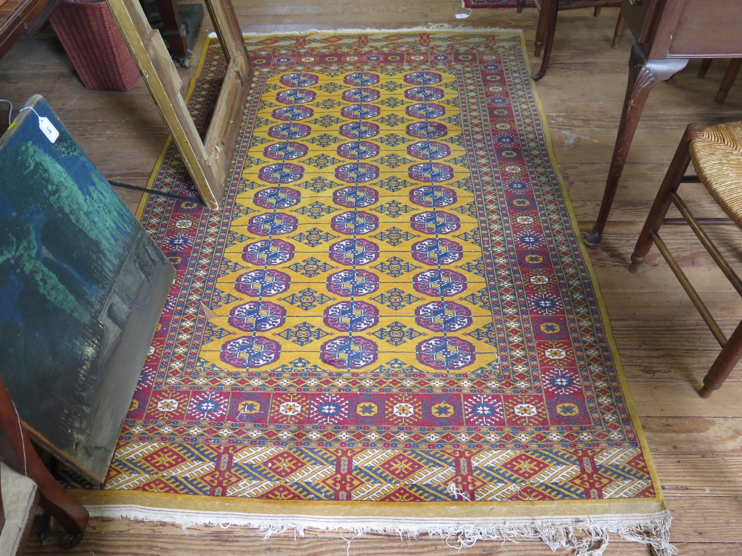 A Bokhara rug, the three rows of guls on a gold colour ground within a multiple border, 206 x 128 cm