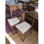 A pair of Regency brass inlaid rosewood dining chairs, the scroll carved backs over later drop-in