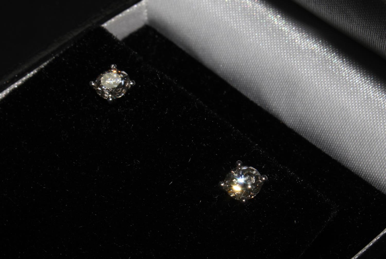 A Pair of 18ct white gold four claw diamond solitaire studs. Boxed. Diamonds 1.16ct total