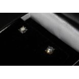 A Pair of 18ct white gold four claw diamond solitaire studs. Boxed. Diamonds 1.16ct total