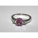 18ct white gold oval pink sapphire and diamond three stone ring. PS1.50ct D 0.35ct.