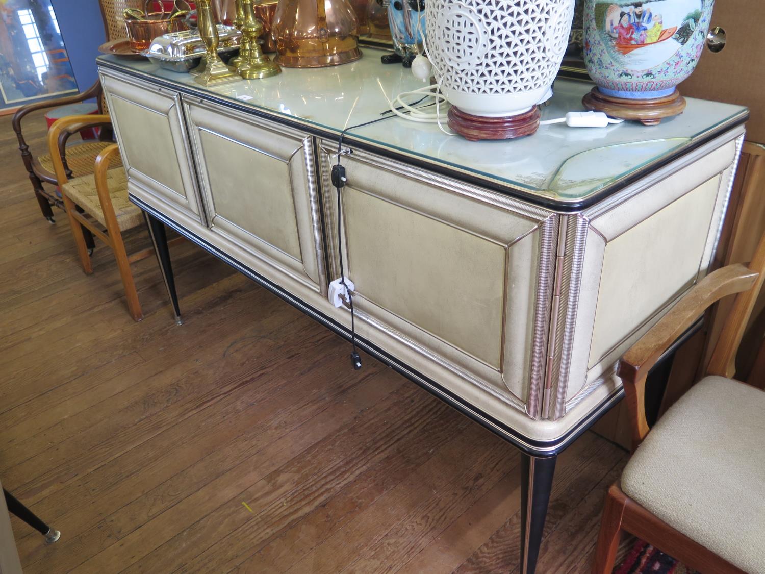 A cream and black faux leather dining room suite by Umberto Mascagni, the sideboard with mirrored