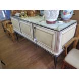 A cream and black faux leather dining room suite by Umberto Mascagni, the sideboard with mirrored