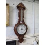 A carved oak banjo barometer, with thermometer and aneroid dial, 87 cm high