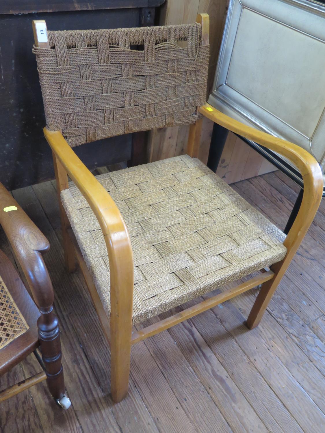 A carver chair, with interwoven rush back and seat and curved arms