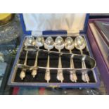 Two sets of six EPNS coffee spoons and a pair of sugar tongs