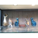 A pair of Poole Pottery cat figures, 16 cm high, another figure of a cat, a Goebels figure of a