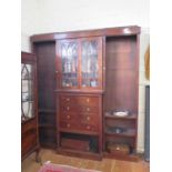 A mahogany breakfront bookcase cabinet, the moulded cornice over a pair of glazed doors above