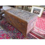 A Chinese camphorwood chest, the lid carved with figures looking out to sailing vessels, 93 x 45 cm,