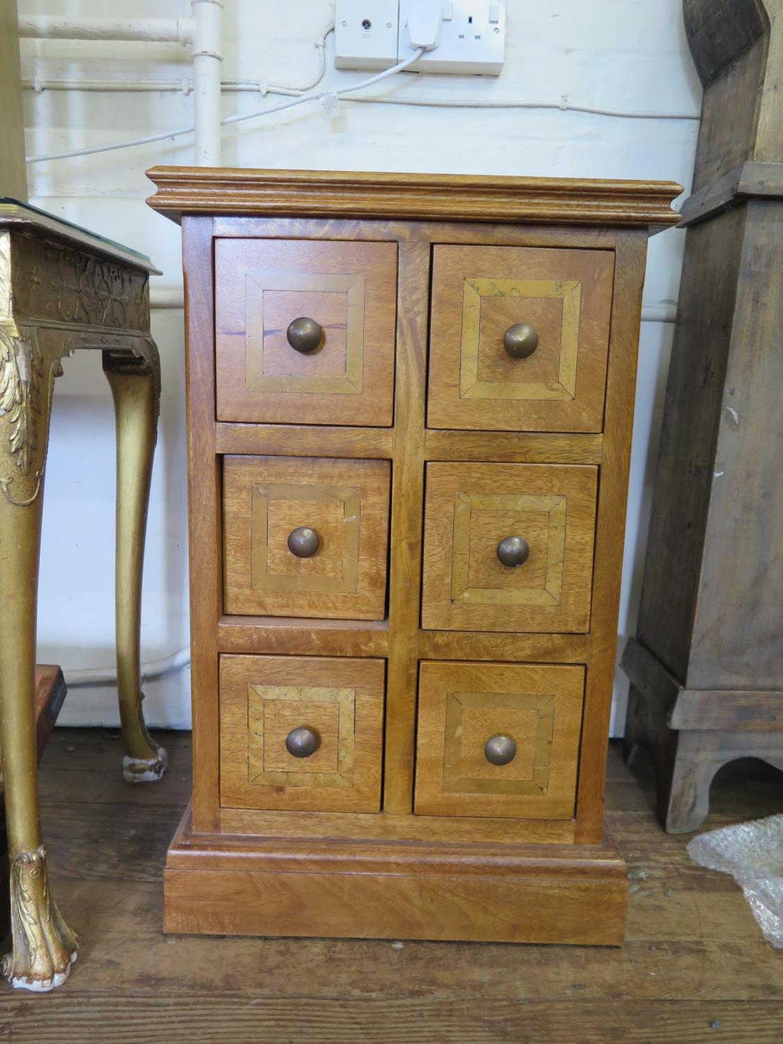 A fruitwood inlaid chest of six square drawers, on a plinth base, 48 cm wide, 48 cm deep, 77 cm high