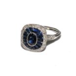 Platinum art deco style sapphire and diamond ring. Centre oval shaped sapphire surrounded by a