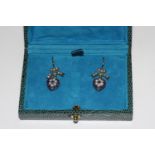 A pair of heart shaped drop earrings set with sapphires, seed pearls and diamonds. Boxed