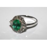 18ct white gold oval emerald and diamond cluster ring. Emerald 1.41ct. Diamonds 0.82ct. Size N