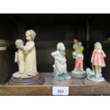 Five continental figures of children all mounted on circular wooden bases comprising Cap Di Monte