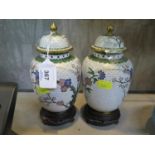 A pair of Chinese cloisonné vases and covers, the flowering branches on a white ground, 20 cm