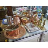 Two large copper conical jugs, a copper kettle, other copper wares, two pairs of brass candlesticks,