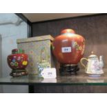 Two Cloisonné ginger jars and covers, both with floral branches on a red ground, largest 17 cm high,