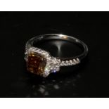 An 18ct white gold fancy brown cushion-cut diamond ring with diamond halo and shoulders. Fancy