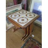 A G-Plan teak nest of three tables, the largest with tiled top, 49 cm wide