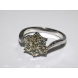 18ct white gold 7 stone diamond floral style cluster ring with diamond shoulders. Diamonds 1.00ct