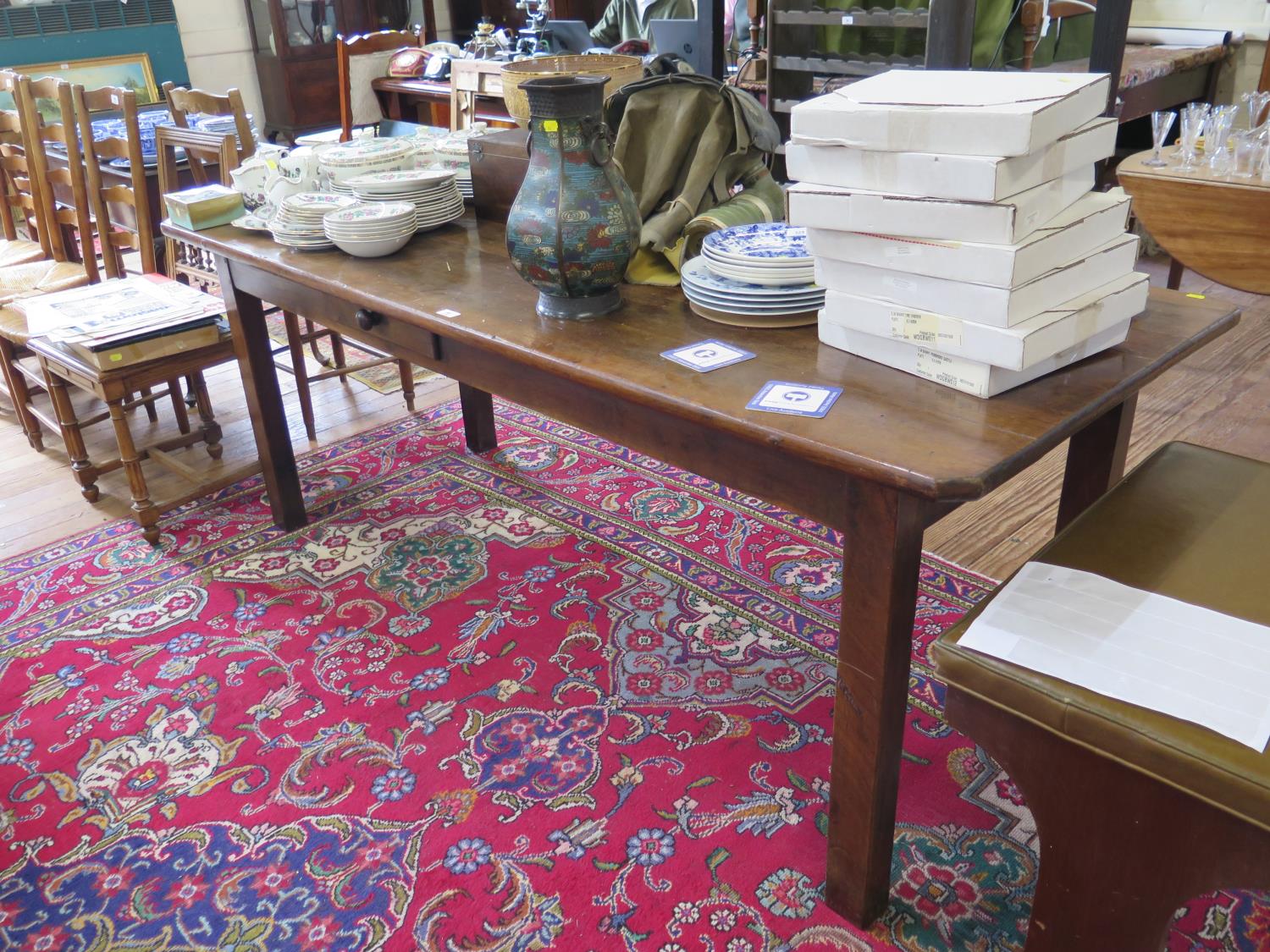 A 19th century French Provincial cherrywood and chestnut dining table, the rectangular top over a