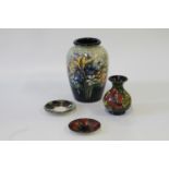 Two Moorcroft saucers, 11 and 12 cm diameter, oviform vase 23cm and a bottle vase 13cm (4)