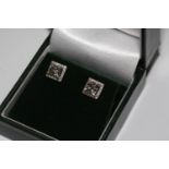 A pair of 18ct white gold princess cut square halo diamond studs. Princess cut diamonds 1.95ct