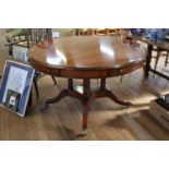 A modern Mahogany veneered centre table. In 19th century style. The circular top fitted with four