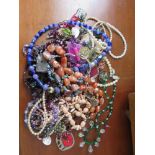 A collection of costume jewellery to include beaded necklaces, earrings, brooches, faux pearls, etc