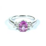 18ct white gold oval pink sapphire and diamond three stone ring. PS1.50ct D 0.35ct. Size L and a