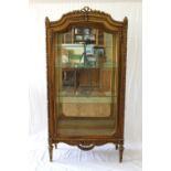 A French Carved Giltwood Mirrored Vitrine. Late 19th/early 20th century. Decorated with a ribbon